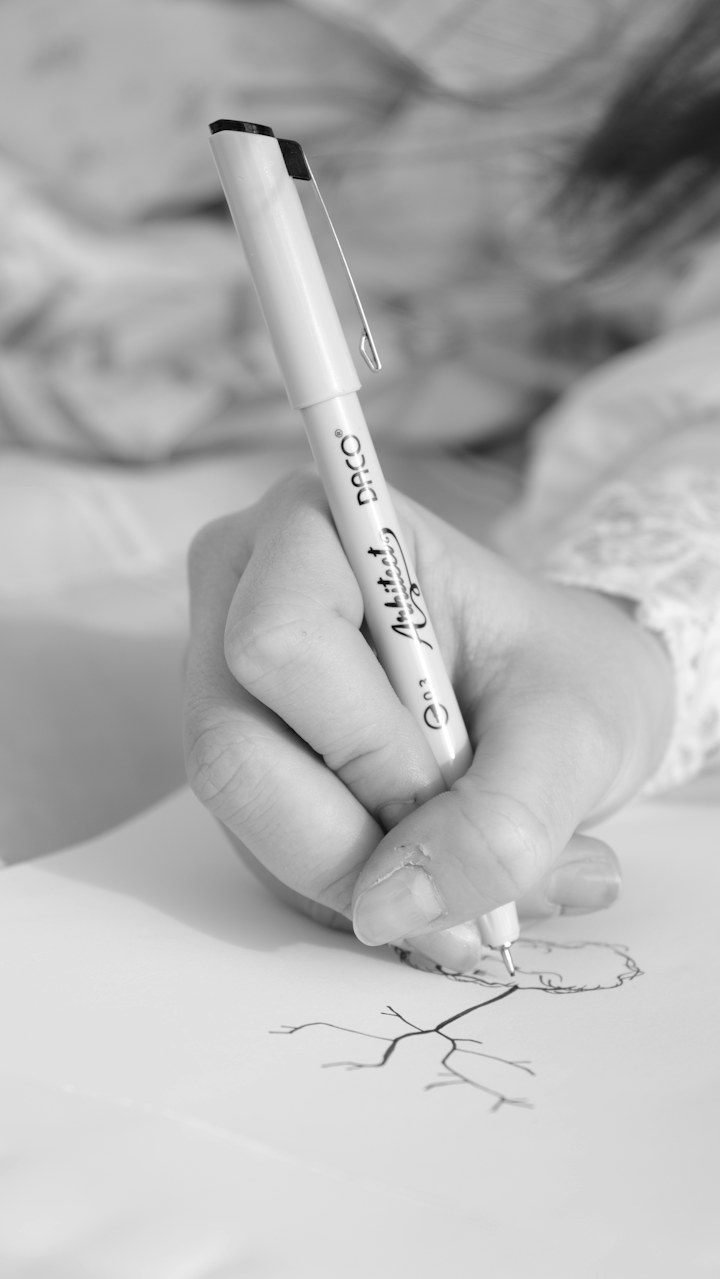 A hand writing an answer on paper